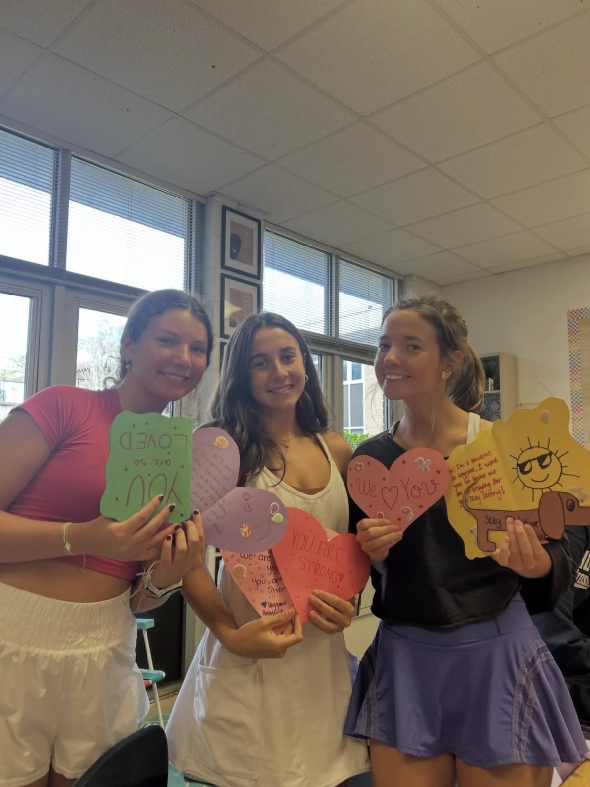 Hoggard IB students holding handmade cards of encouragement