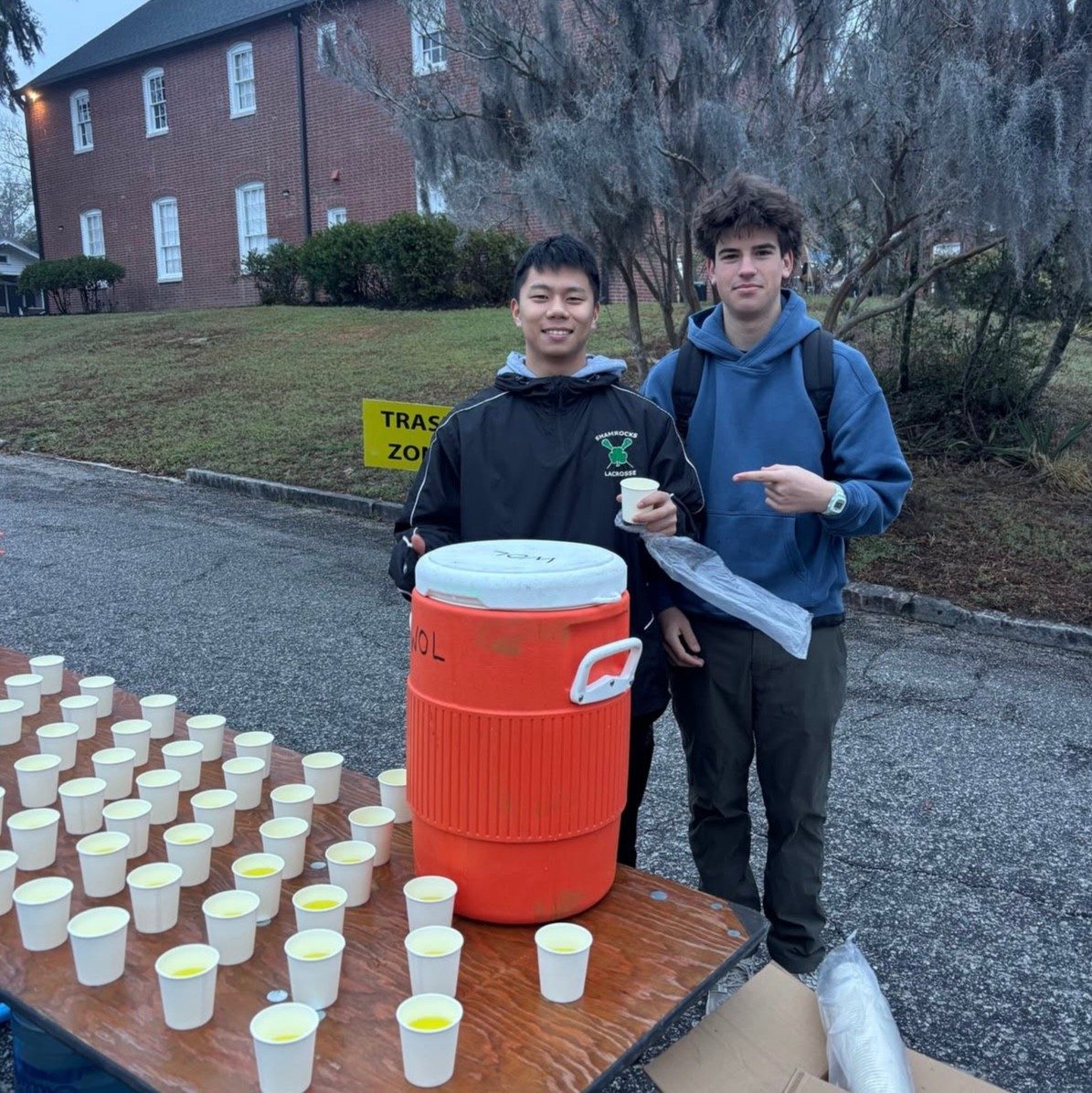 Two Hoggard IB students volunteering at a race water station