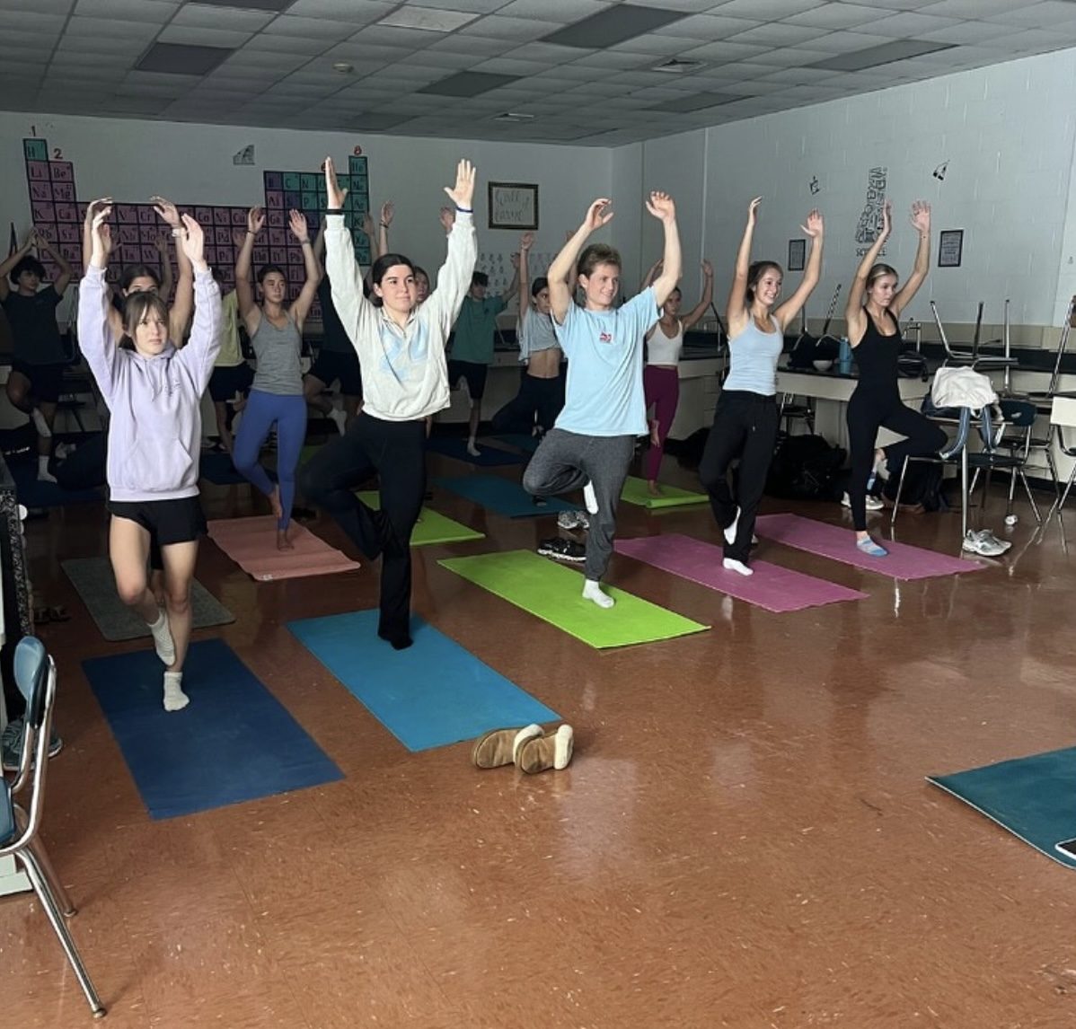 Hoggard IB students doing yoga together in a classroom