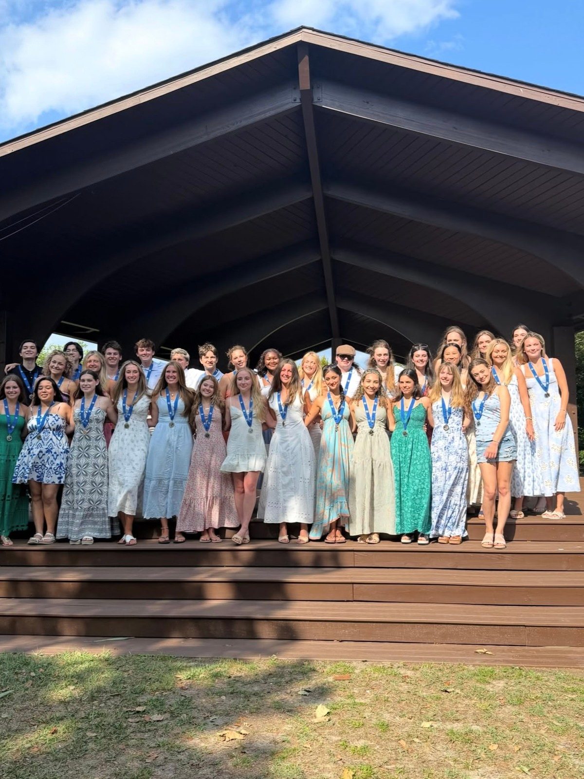 Hoggard IB graduates with their medals at an outdoor ceremony